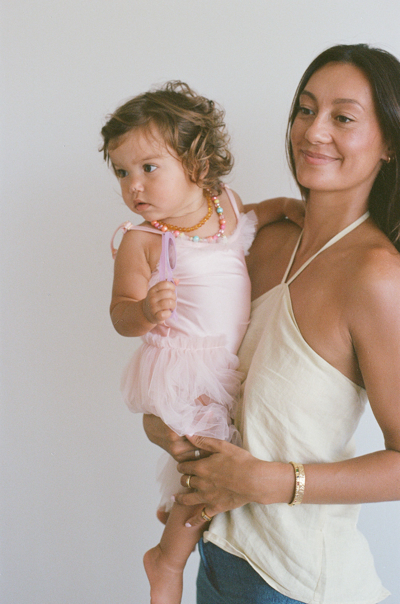 A mum holding her mini in a tutu